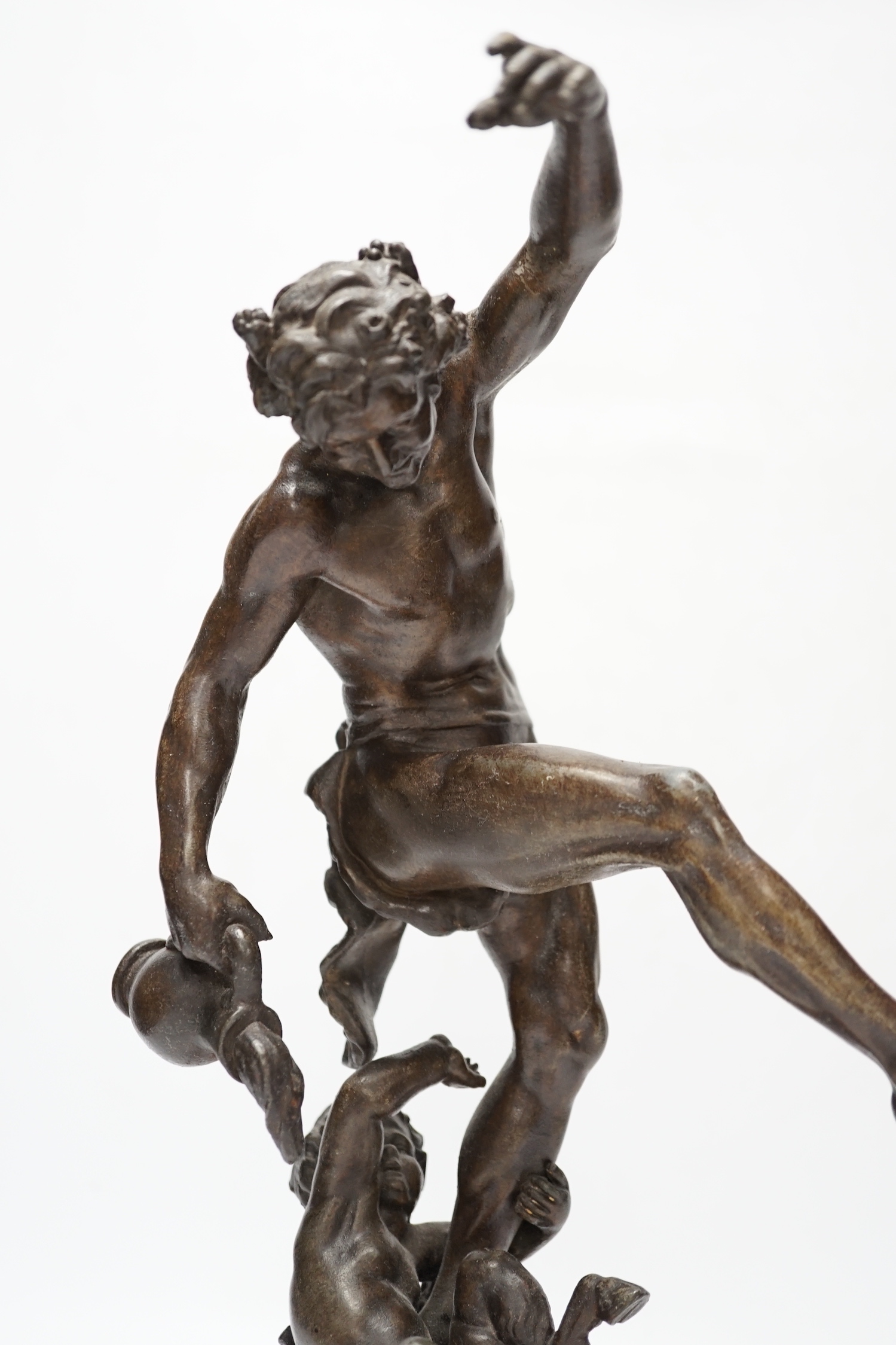A bronzed spelter dancing figure of Bacchus - ‘Le Vin’, with a fawn and bunches of grapes, on a marble base, 36cm high